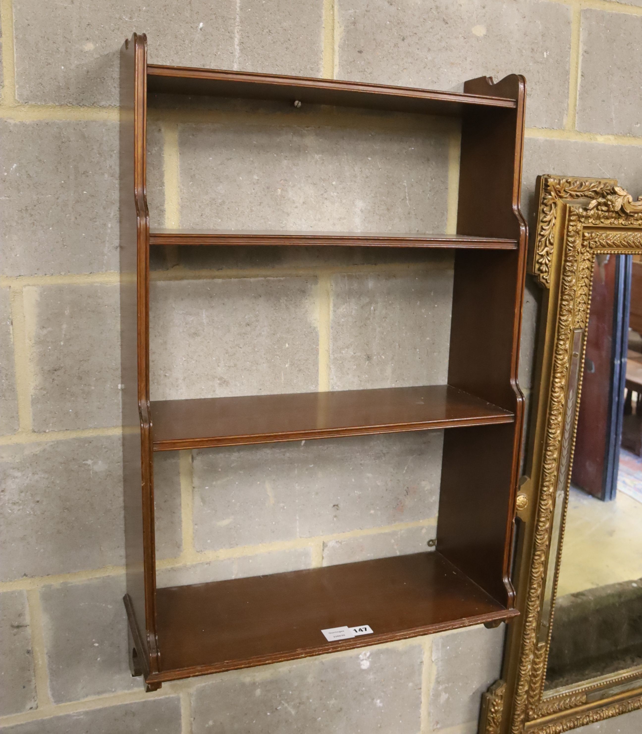 A mahogany three shelf wall bracket, width 57cm, depth 23cm, height 94cm